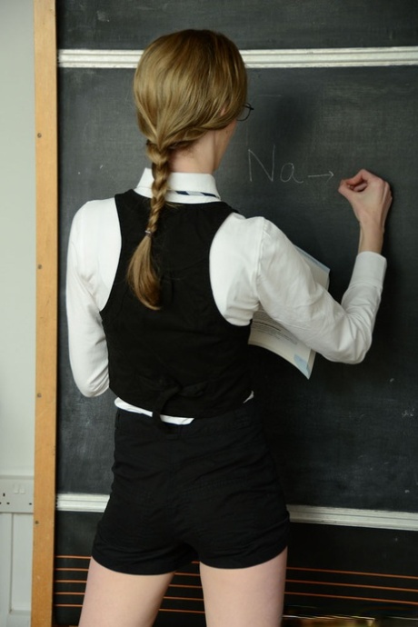 Schoolgirl Melissa Thompson stands at the chalkboard after stripping naked