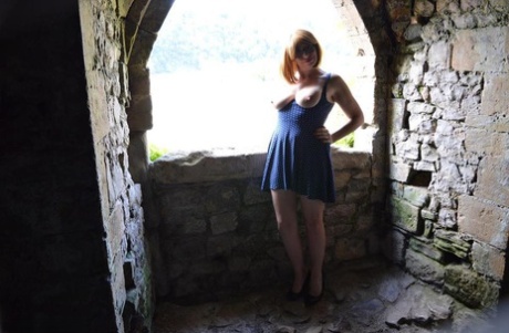Redheaded amateur Barby Slut gets totally naked while wandering castle grounds