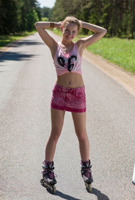 Young blonde girl Faina gets naked in middle of road wearing roller blades