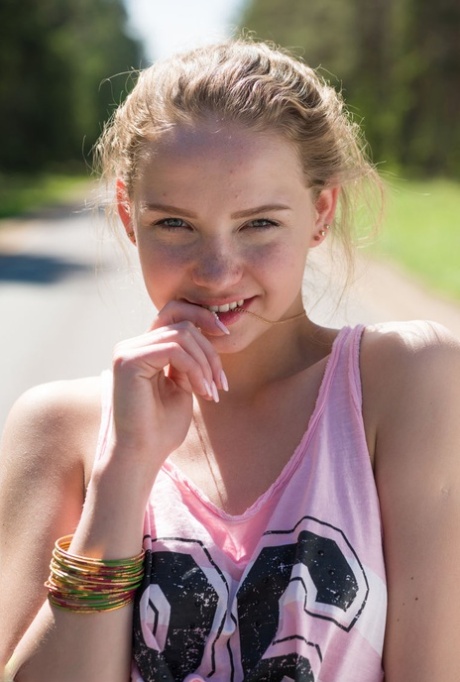 Young blonde girl Faina gets naked in middle of road wearing roller blades