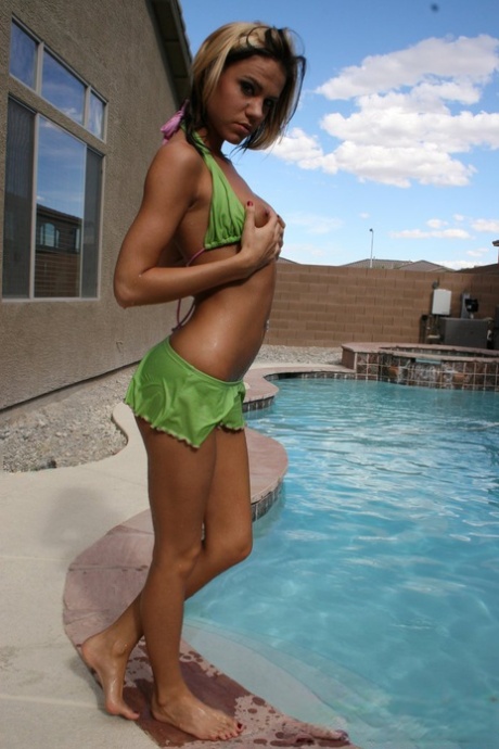 Amateur girl Addison St James frees her tiny tits from a bikini top in a pool