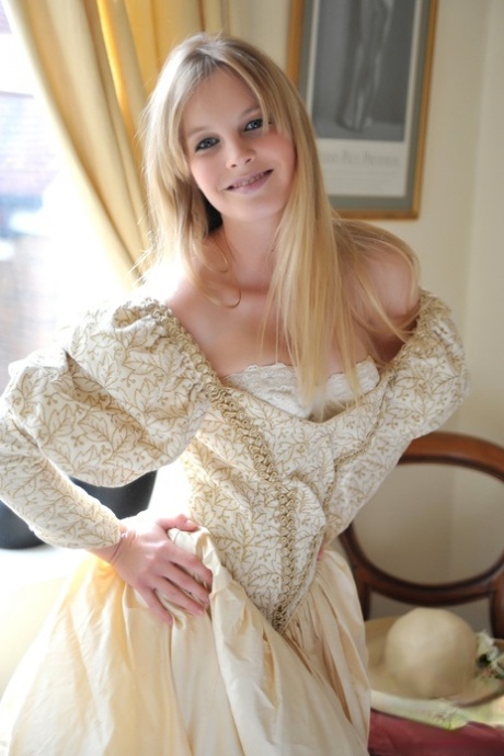 Blonde girl Rose takes off her petticoat to model in a girdle and nylons