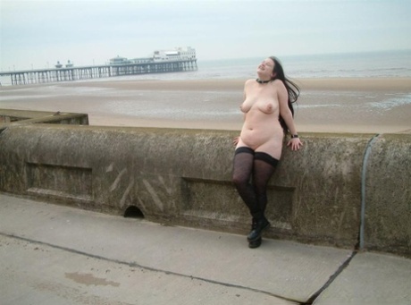 Overweight brunette gets naked in public while wearing stockings and Docs