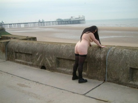 Overweight brunette gets naked in public while wearing stockings and Docs