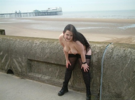 Overweight brunette gets naked in public while wearing stockings and Docs