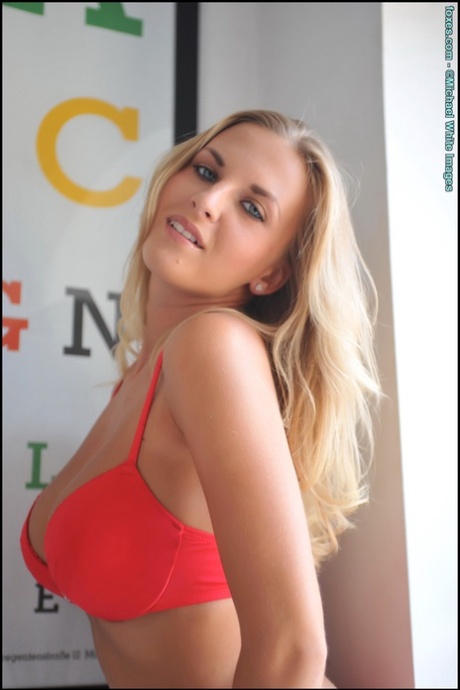 Beautiful blonde Chikita displays her great tits during a solo session