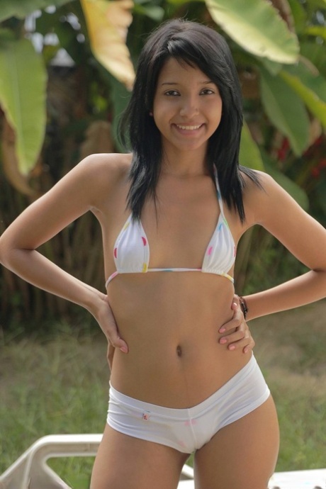 Wild teen Carol Lopez loses her bikini to show her perfect round ass outdoors