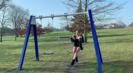Blonde chick Claudia Macc hikes up her skirt to take a pee while on a swing