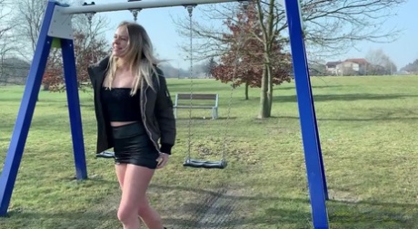 Blonde chick Claudia Macc hikes up her skirt to take a pee while on a swing