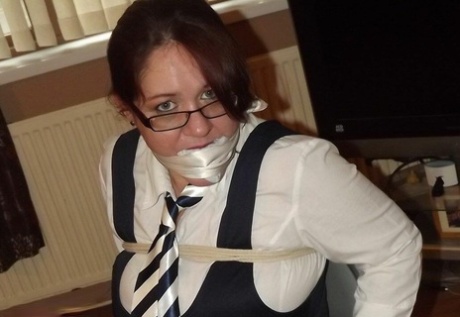Overweight schoolgirl has her large tits exposed while gagged and restrained