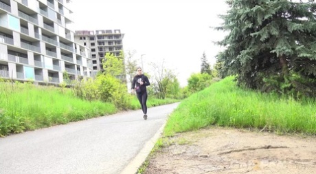 Clothed girl Lara Fox pulls down black leggings to pee by the side of a road