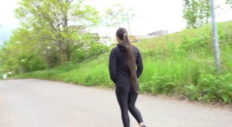 Clothed girl Lara Fox pulls down black leggings to pee by the side of a road