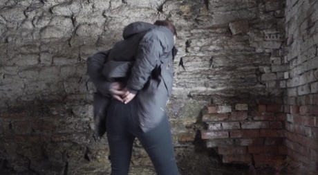 White girl Alexa pulls down her leggings to pee in an abandoned cellar
