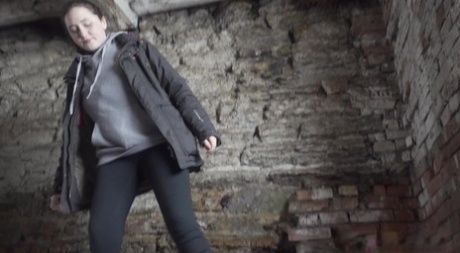 White girl Alexa pulls down her leggings to pee in an abandoned cellar
