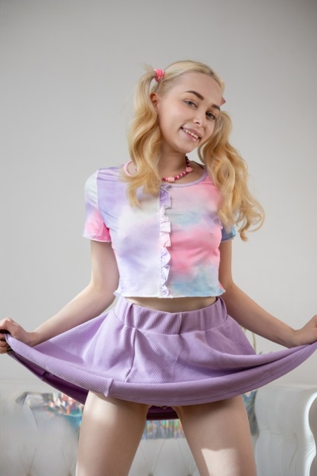 Young looking teen Xene wears her blonde hair in pigtails while getting naked