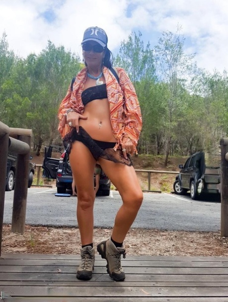 Brunette MILF Roxeanne shows her snatch at a public park