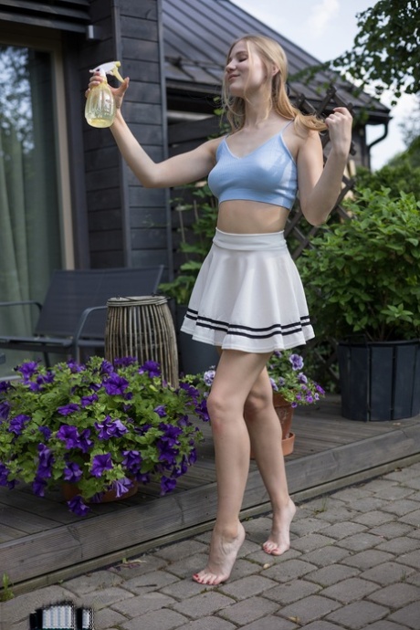 Blonde teen Lucia spritz her great body after getting totally naked