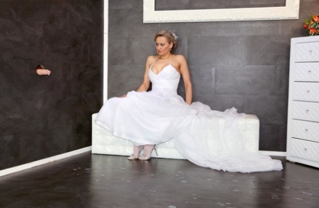 Blonde chick in a wedding dress gets doused in sperm at a gloryhole