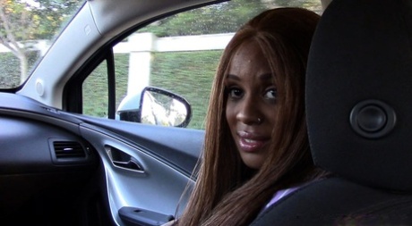 Ebony solo girl exposes pierced nipples and shaved pussy in vehicle
