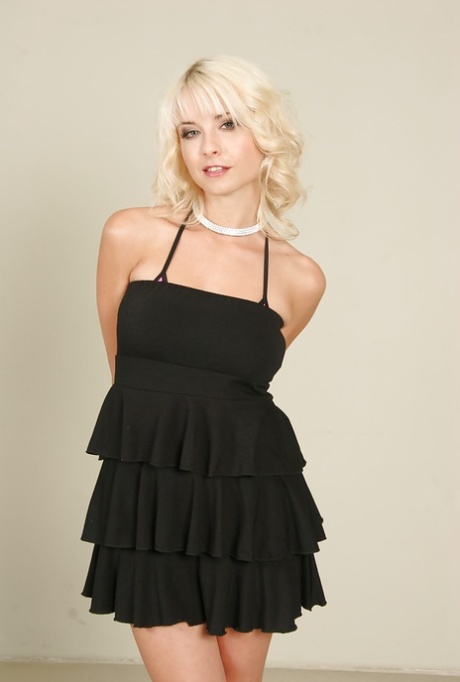 Beautiful blond pornstar Mia Magma doffs black dress and lingerie to pose nude