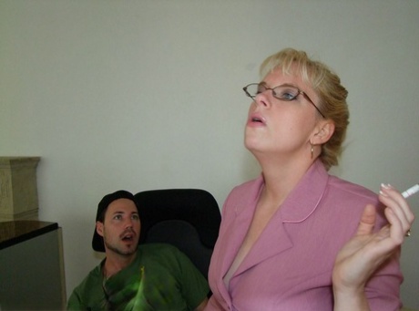 Smoking mature blonde in glasses gets a cumshot on her big tits