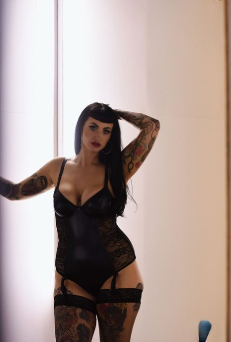 Thick model Cherrie Pie flaunts her tattooed body and big tits in lingerie
