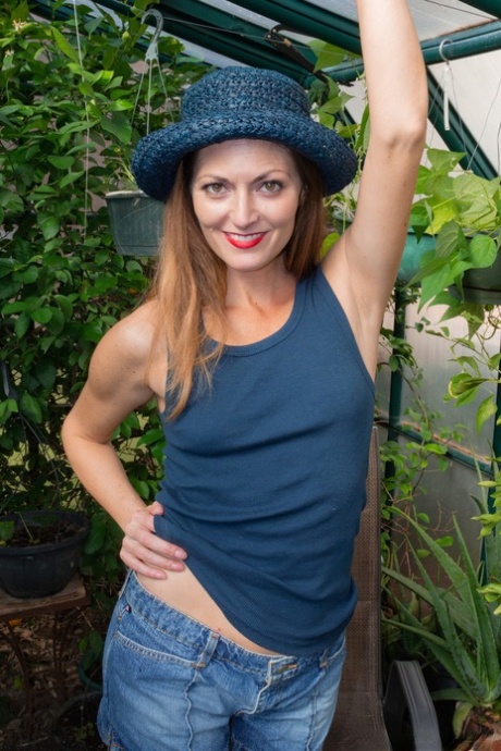 Stunner with a hat Vanessa Bush strips & toys her furry pussy in a green house