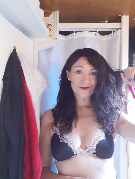 Sexy MILF Kitty Cream models for a non-nude shoot while at home and alone