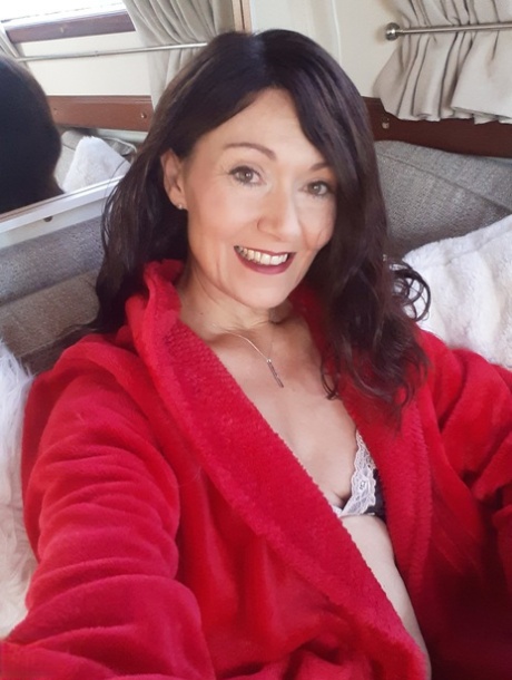 Sexy MILF Kitty Cream models for a non-nude shoot while at home and alone