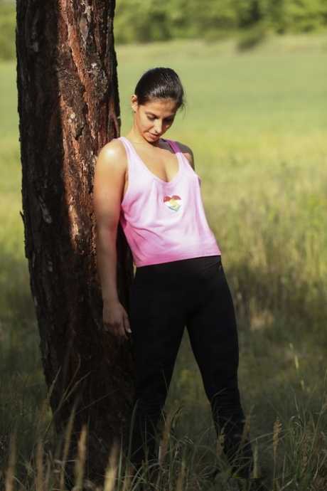 Cute teen Angela Allison unveils her small titties and masturbates in nature