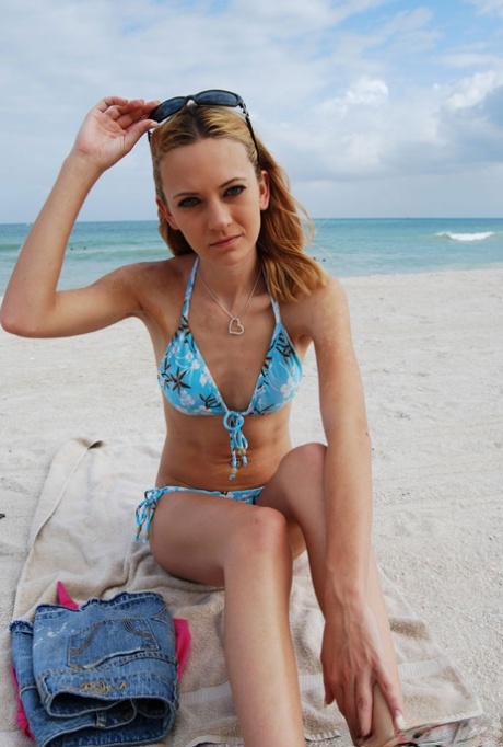 Skinny chick in bikini Michelle poses for the camera and flashes her titties
