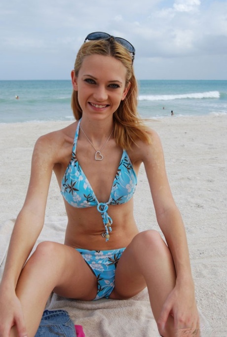 Skinny chick in bikini Michelle poses for the camera and flashes her titties