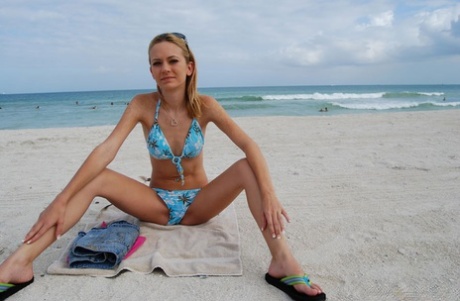 Skinny chick in bikini Michelle poses for the camera and flashes her titties