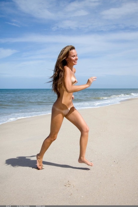 Petite teen Aria R romping naked at the beach showing off her perky titties