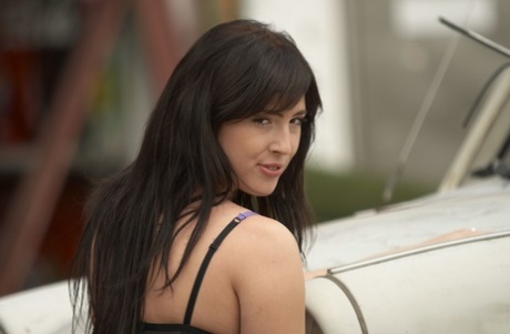 Sultry brunette Bijou takes off sensual lingerie in a dusty junkyard