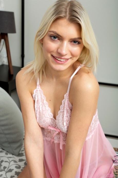 Gorgeous teen babe Lesya strips her pink nightgown & massages her pussy