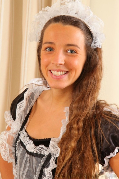 Adorable brunette maid Esmee takes off her uniform and shows her hot figure