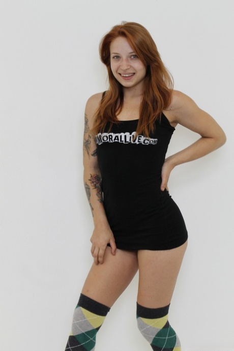 Inked ginger Alyssa Branch undresses and poses provocatively in a solo