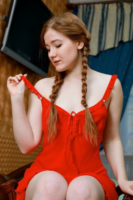 Glamorous teen babe Anicka strips her red dress and fingers her coochie