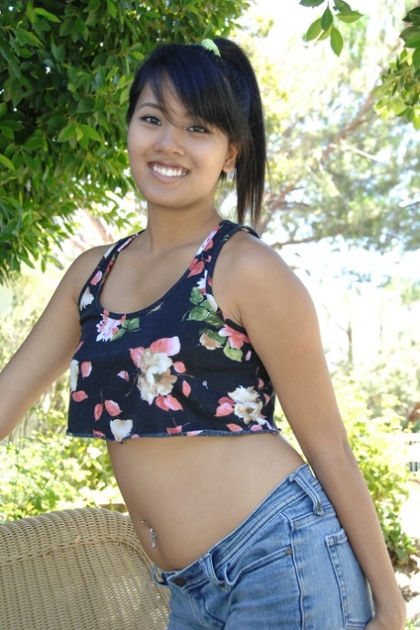 Cute Asian girl Angelina Chung exposes her fabulous butt and poses outdoors
