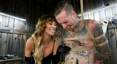 Busty dominatrix Cherie DeVille pegs and fucks her tied up inked slave