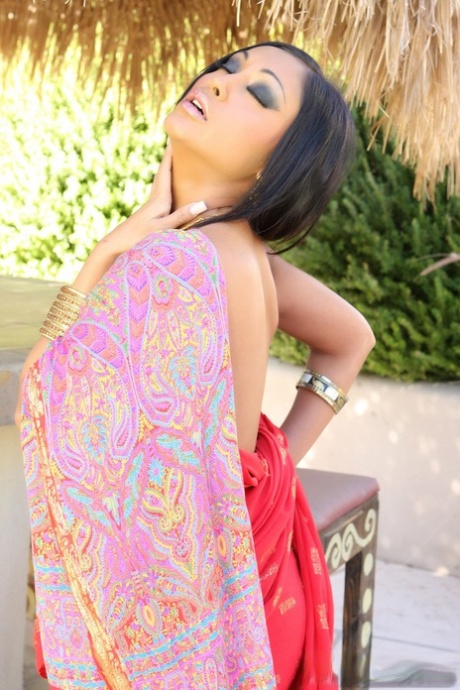 Busty MILF in a red dress Priya Anjali Rai shows her incredible tits outdoors