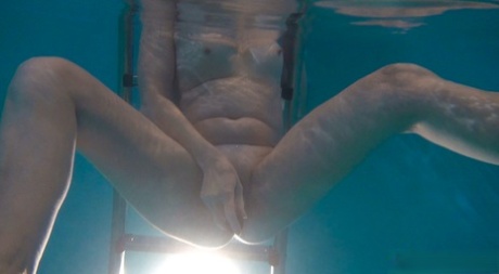 Horny granny Jitka masturbating in the pool during a nude swim session