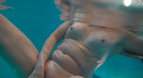 Horny granny Jitka masturbating in the pool during a nude swim session