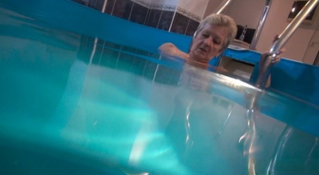 Horny granny Jitka masturbating in the pool during a nude swim session