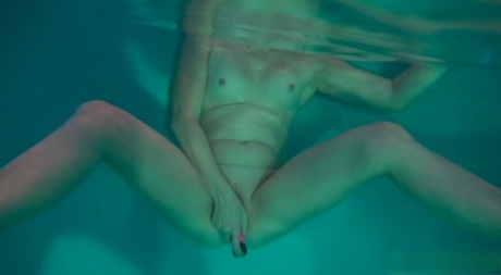 Horny granny Jitka masturbating in the pool during a nude swim session