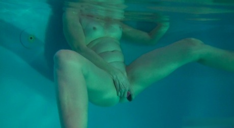 Horny granny Jitka masturbating in the pool during a nude swim session