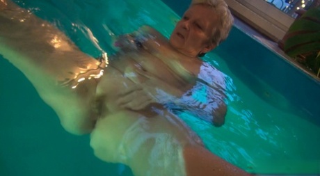 Horny granny Jitka masturbating in the pool during a nude swim session