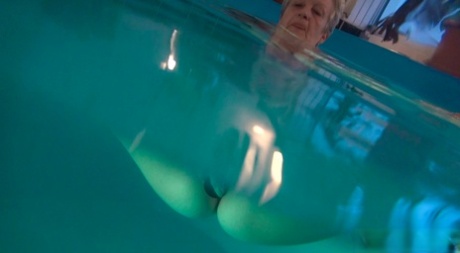 Horny granny Jitka masturbating in the pool during a nude swim session