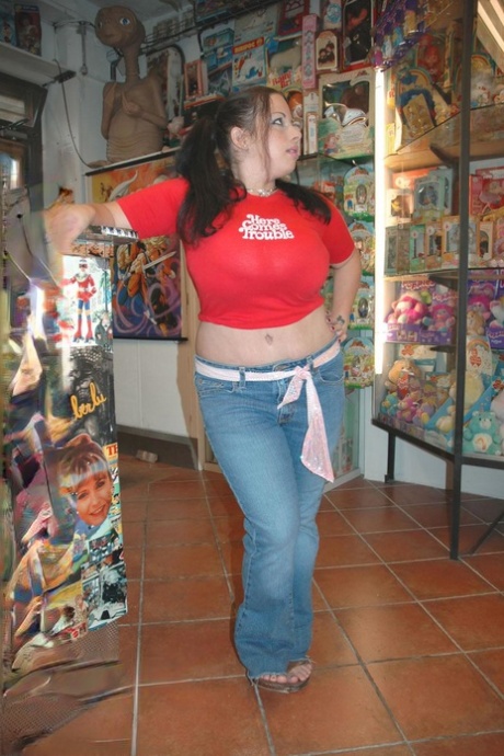 Chubby amateur MILF Devyn Devine plays with her monster tits at the toy shop
